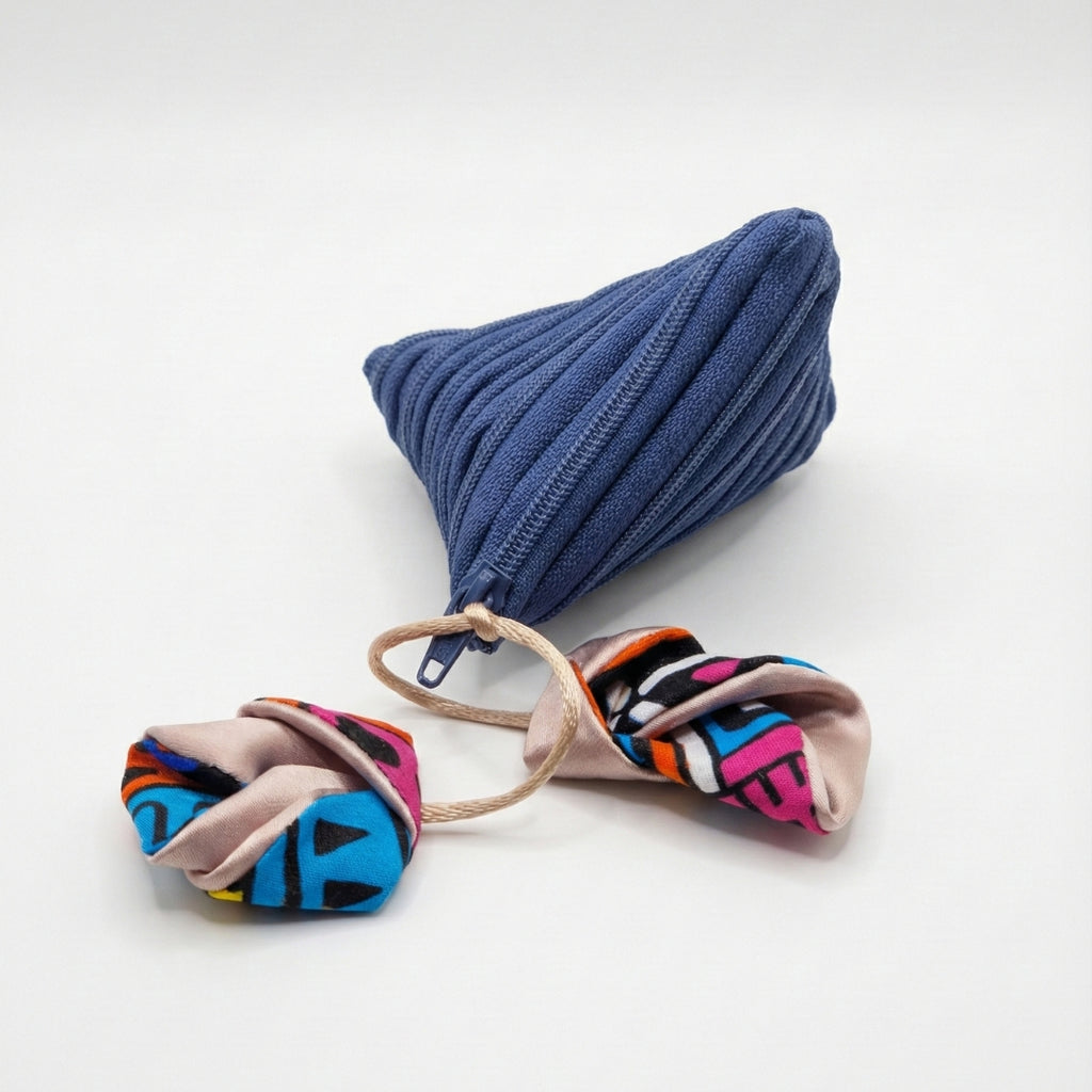 Blue triangular coin purse with African print pendant.