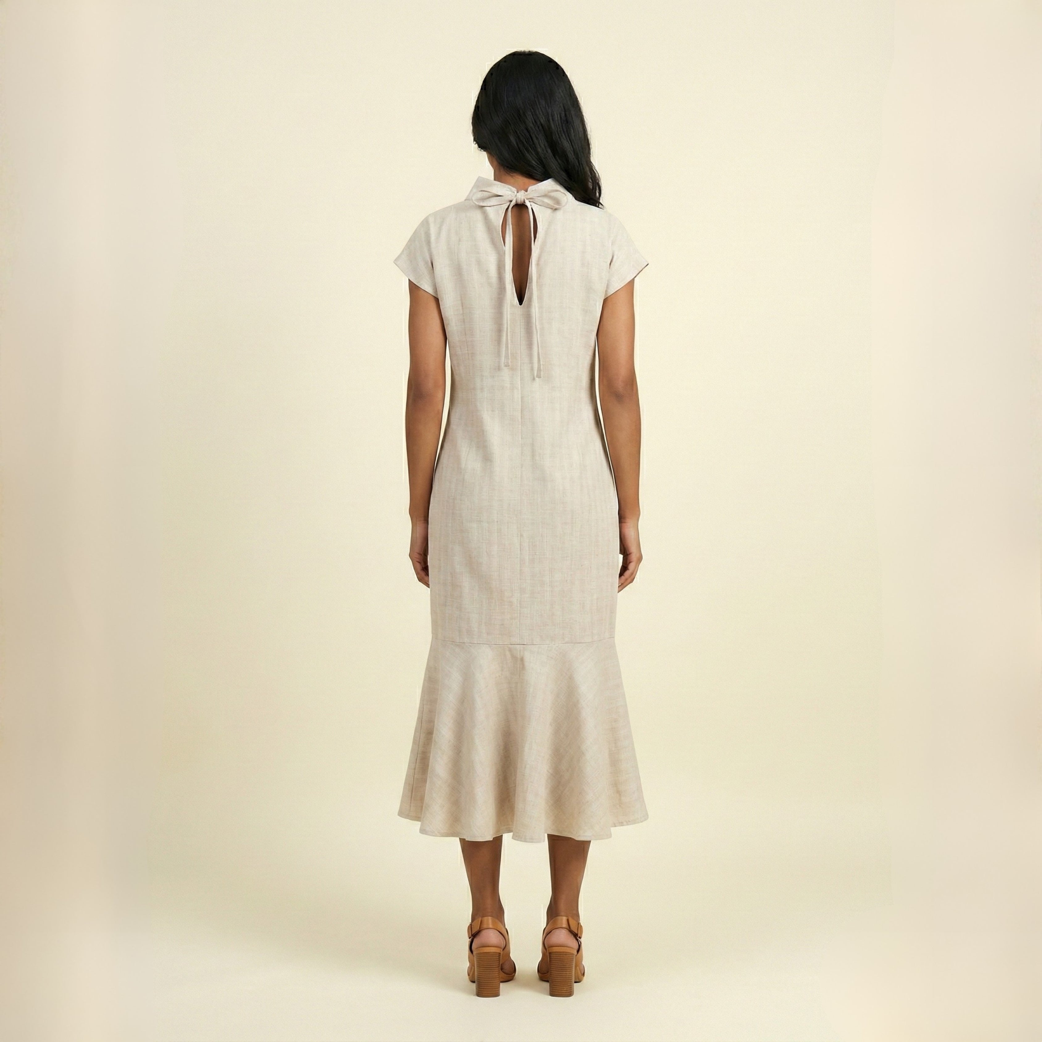 High-neck dress with tie closure.
